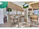 Outdoor bar with tiki accents, seating, and televisions at 2614 Lodi Cir # 106, Kissimmee, FL 34746