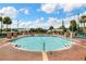 Large swimming pool with poolside lounge chairs and fountain features in a lovely community at 2614 Lodi Cir # 106, Kissimmee, FL 34746