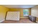 Bedroom with carpeted floors, a window with blinds, a mattress, and a dresser at 2652 N Woodland Blvd, Deland, FL 32720