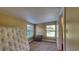 Bedroom featuring neutral carpet, small cabinet, and natural lighting from double windows at 2652 N Woodland Blvd, Deland, FL 32720