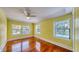 Bright bedroom with polished hardwood floors and multiple windows at 2652 N Woodland Blvd, Deland, FL 32720