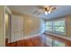 Bedroom with hardwood floors, ceiling fan with lighting, and natural light from windows at 2652 N Woodland Blvd, Deland, FL 32720
