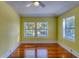 Bedroom featuring hardwood floors, ceiling fan, and bright natural light from double windows at 2652 N Woodland Blvd, Deland, FL 32720