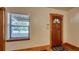 Entryway featuring hardwood floors, a window with blinds, and a wood-trimmed door with decorative glass at 2652 N Woodland Blvd, Deland, FL 32720