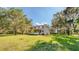 A charming two-story home featuring a welcoming porch and surrounded by lush greenery at 2652 N Woodland Blvd, Deland, FL 32720