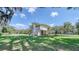 Two-story home with a covered patio in a green yard at 2652 N Woodland Blvd, Deland, FL 32720