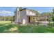 Side exterior of two-story home with a covered patio and a green lawn at 2652 N Woodland Blvd, Deland, FL 32720