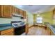 Sunlit kitchen featuring laminate countertops and tiled floors at 2652 N Woodland Blvd, Deland, FL 32720
