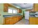 Functional kitchen with wooden cabinets and neutral countertops at 2652 N Woodland Blvd, Deland, FL 32720