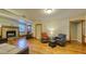 Inviting living room featuring hardwood floors, a fireplace, and comfortable seating with lots of space at 2652 N Woodland Blvd, Deland, FL 32720