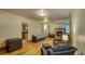 An open-concept living room with a fireplace, hardwood floors, and wicker furniture creates an inviting atmosphere at 2652 N Woodland Blvd, Deland, FL 32720