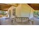A relaxing porch area with seating, including a bench swing with heart cutouts and wood flooring at 2652 N Woodland Blvd, Deland, FL 32720