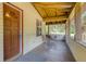 A porch seating area with a swing, chair, and stained wood ceiling outside front door at 2652 N Woodland Blvd, Deland, FL 32720