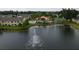 Aerial view of community pool area with fountain lake, manicured lawns and nearby tennis courts at 2798 Club Cortile Cir # A, Kissimmee, FL 34746