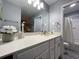 This bathroom features a long vanity, white cabinets, and grey walls at 2798 Club Cortile Cir # A, Kissimmee, FL 34746