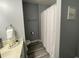 Bathroom features a toilet, towel rack, shower, and white vanity at 2798 Club Cortile Cir # A, Kissimmee, FL 34746