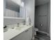 Bathroom featuring a long vanity with white cabinets and grey walls at 2798 Club Cortile Cir # A, Kissimmee, FL 34746
