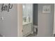 View through a doorway of the bathroom and white vanity at 2798 Club Cortile Cir # A, Kissimmee, FL 34746