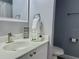 Bathroom featuring a vanity, toilet, and white cabinets at 2798 Club Cortile Cir # A, Kissimmee, FL 34746