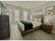 Bedroom with wood floors, a wooden headboard, and many windows at 2798 Club Cortile Cir # A, Kissimmee, FL 34746