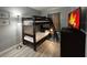 This bedroom features a bunk bed, a dresser with a TV and stylish light gray flooring at 2798 Club Cortile Cir # A, Kissimmee, FL 34746