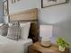 Bedroom detail of a nightstand with lamp and greenery at 2798 Club Cortile Cir # A, Kissimmee, FL 34746