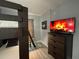 This bedroom features a bunk bed, a TV on a chest of drawers, and modern gray flooring at 2798 Club Cortile Cir # A, Kissimmee, FL 34746