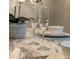 Close up view of a champagne glass and dining setting in the dining room with grey walls at 2798 Club Cortile Cir # A, Kissimmee, FL 34746