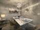 Dining room with a table, chandelier, hard wood floors, seating for four, and decorative wall art at 2798 Club Cortile Cir # A, Kissimmee, FL 34746