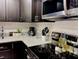 Modern kitchen featuring dark cabinets, stainless steel appliances, and granite countertops at 2798 Club Cortile Cir # A, Kissimmee, FL 34746