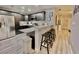 Kitchen with a breakfast bar, stainless steel appliances, dark cabinetry, and granite countertops at 2798 Club Cortile Cir # A, Kissimmee, FL 34746