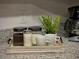 Close up view of a coffee and sugar station in the kitchen with granite countertops and grey walls at 2798 Club Cortile Cir # A, Kissimmee, FL 34746