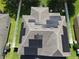 Aerial view of a home with solar panels on the roof and a well-manicured lawn at 3003 Cobham Rd, Kissimmee, FL 34758