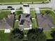 The house is surrounded by a well-maintained lawn and mature trees, providing a serene and private setting at 3003 Cobham Rd, Kissimmee, FL 34758