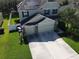 Aerial view of a two-story home with solar panels and a two-car garage at 3003 Cobham Rd, Kissimmee, FL 34758