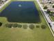 Aerial view of a large retention pond inside of a community of homes at 3003 Cobham Rd, Kissimmee, FL 34758
