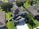 Aerial view of a two-story home with solar panels and a two-car garage at 3003 Cobham Rd, Kissimmee, FL 34758