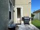 A home's back patio featuring a grill and direct access to the backyard at 3003 Cobham Rd, Kissimmee, FL 34758