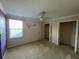 Spacious bedroom featuring a ceiling fan, a window, and ample closet space at 3003 Cobham Rd, Kissimmee, FL 34758