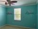 Turquoise bedroom featuring mermaid decals, a ceiling fan, and window at 3003 Cobham Rd, Kissimmee, FL 34758