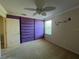 Bright bedroom featuring a ceiling fan, window and purple accent wall at 3003 Cobham Rd, Kissimmee, FL 34758
