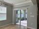 Bright dining room with tile flooring, chandelier lighting, and sliding glass door leading to patio at 3003 Cobham Rd, Kissimmee, FL 34758