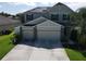 A charming two-story home with a two car garage and appealing stone and siding details at 3003 Cobham Rd, Kissimmee, FL 34758