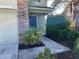 Well-maintained front entrance with a walkway leading to the door and lush landscaping at 3003 Cobham Rd, Kissimmee, FL 34758