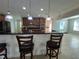 Open-concept kitchen features granite bar, stainless appliances, tile backsplash and wooden cabinets at 3003 Cobham Rd, Kissimmee, FL 34758