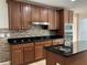 Lovely kitchen boasts stainless appliances, tile backsplash, wood cabinetry and granite countertops at 3003 Cobham Rd, Kissimmee, FL 34758