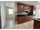 Open kitchen features wooden cabinetry, granite counters and backsplash, and stainless appliances at 3003 Cobham Rd, Kissimmee, FL 34758