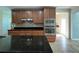 Modern kitchen featuring stainless steel appliances, granite countertops, and a breakfast bar at 3003 Cobham Rd, Kissimmee, FL 34758