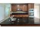 Beautiful kitchen features granite counters, tile backsplash, stainless appliances and wooden cabinets at 3003 Cobham Rd, Kissimmee, FL 34758