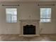 Living room with a fireplace and two windows at 3003 Cobham Rd, Kissimmee, FL 34758